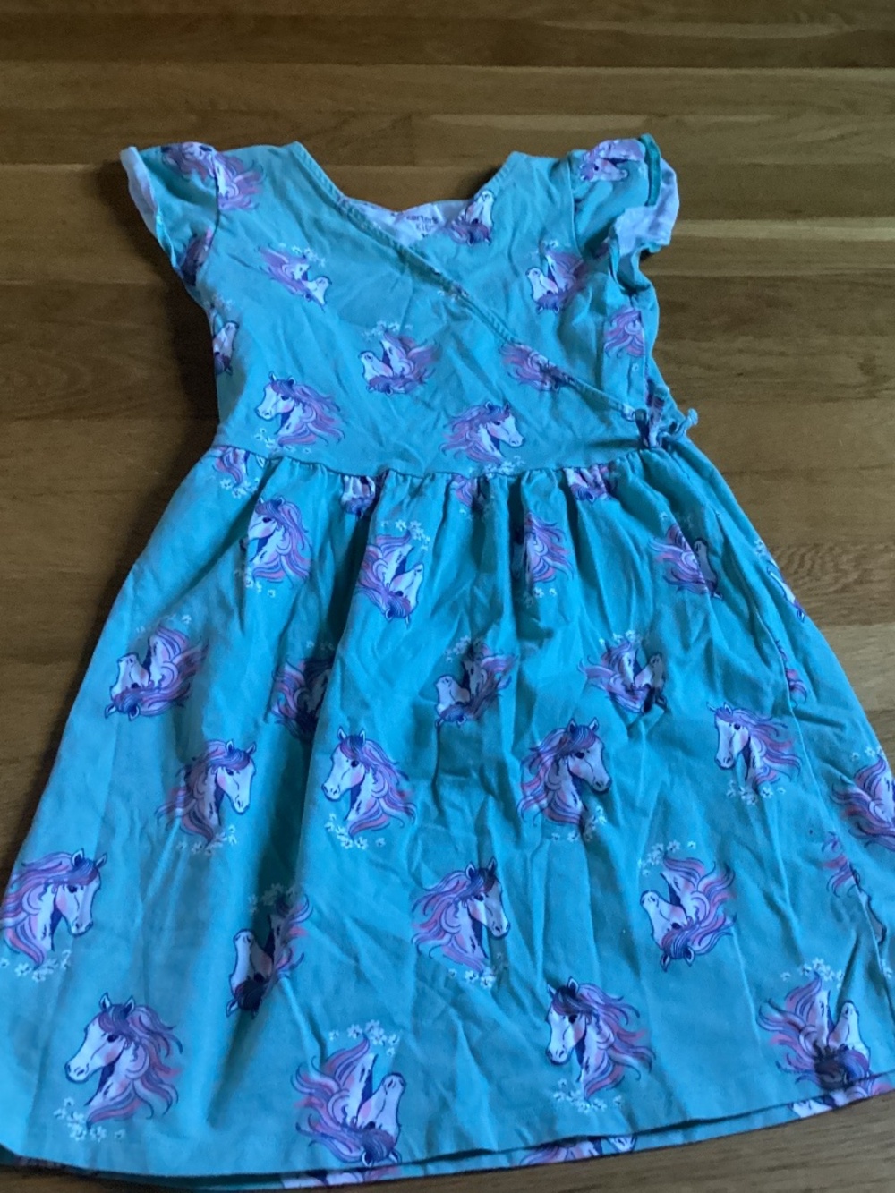 A Carter’s kid size 10 sage green dress with unicorns